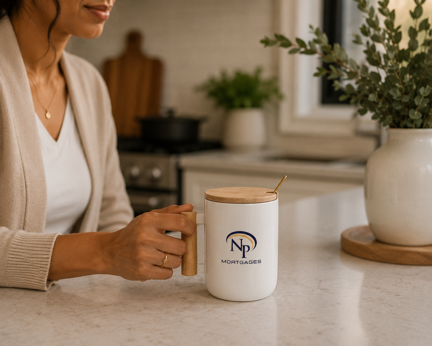 Woman holding a branded NP Mortgages coffee mug in a modern kitchen